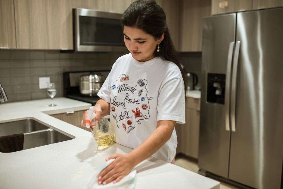 Detail-oriented wiping of a kitchen counter during a deep clean